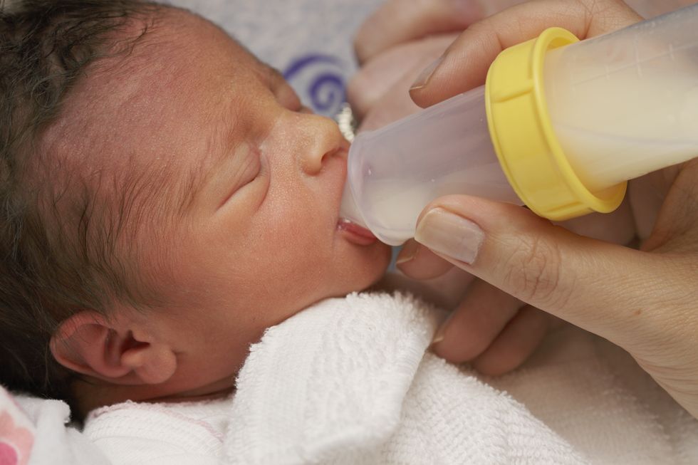 newborn preemie with bottle