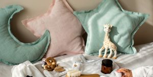 newborn unisex baby necessities and clothing on cozy nursery in morning sunlights baby shower concept