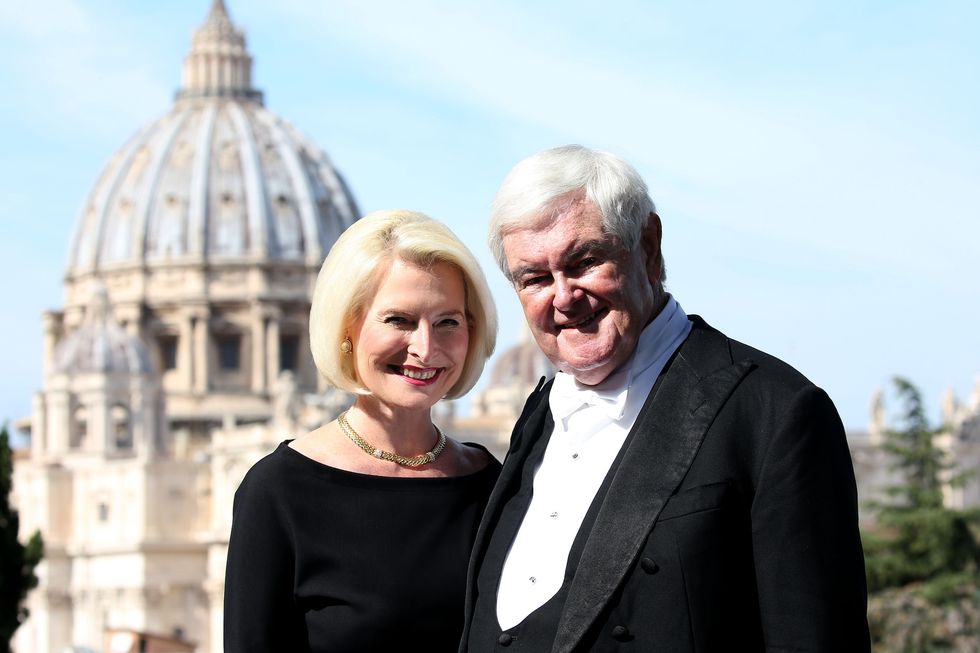 vatican city, vatican   october 13 newt gingrich and us ambassador callista gingrich pose in front the st peter's basilica during a reception for the cardinal newman canonisation at pontifical urban college on october 13, 2019 in vatican city, vatican photo by franco origliagetty images