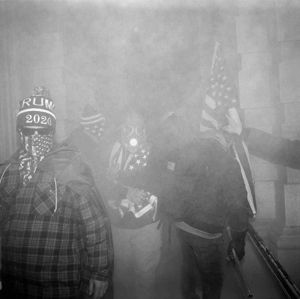 Tijdens de rellen bij het Capitool op 6 januari staan aanhangers van Trump in wolken traangas pepperspray en poeder uit blusapparaten die als wapen tegen de politie worden ingezet