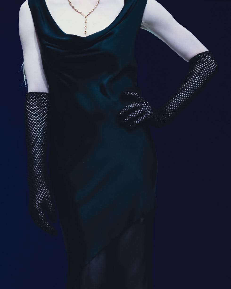 elegant evening attire featuring a black satin dress and long fishnet gloves