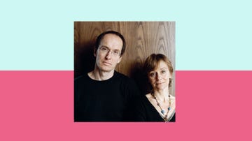 two individuals standing side by side against a wooden background