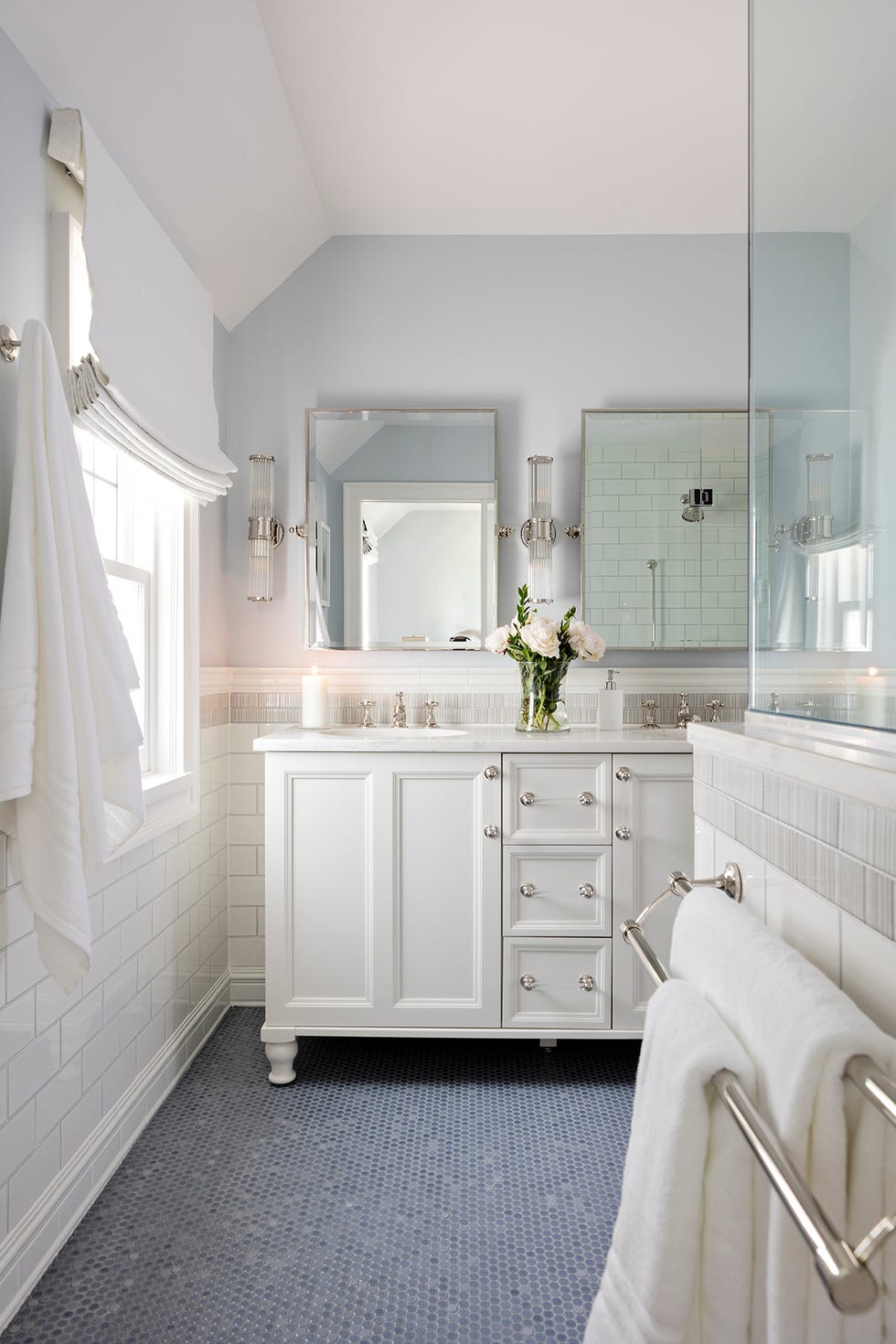 modern bathroom featuring a white vanity mirrors and a blue tiled floor