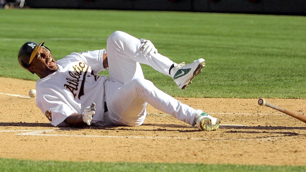 nick lammers trib sports 101301oakland as jermaine dye falls to the ground in pain after fouling a ball off of his knee during the third inning of the fourth game of the american leauge divisional series against the new york yankees at network