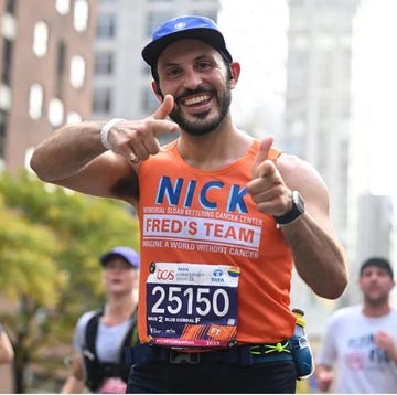 a man wearing a hat and running