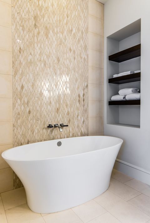 neutral bathroom with tub and tile