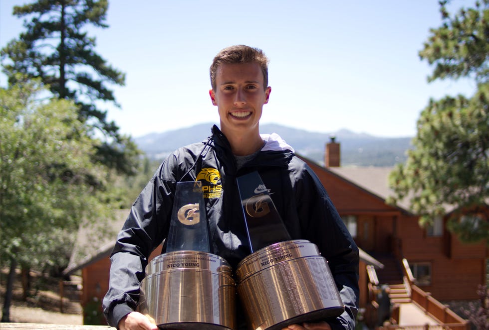 nico young holding both of his gatorade player of the year awards he won both in 2020