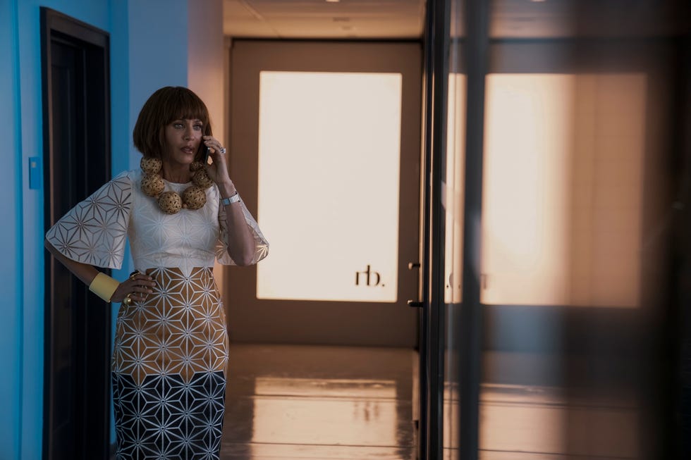A person in a stylish outfit posing in a hallway