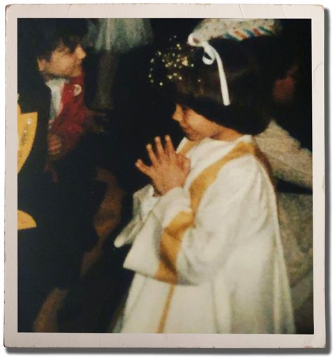 author as a young child with hands clasped making her first communion