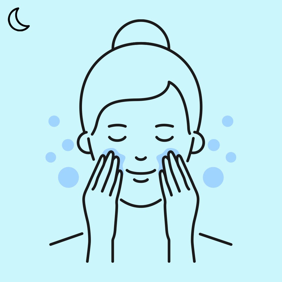 woman applying cleanser on face at night