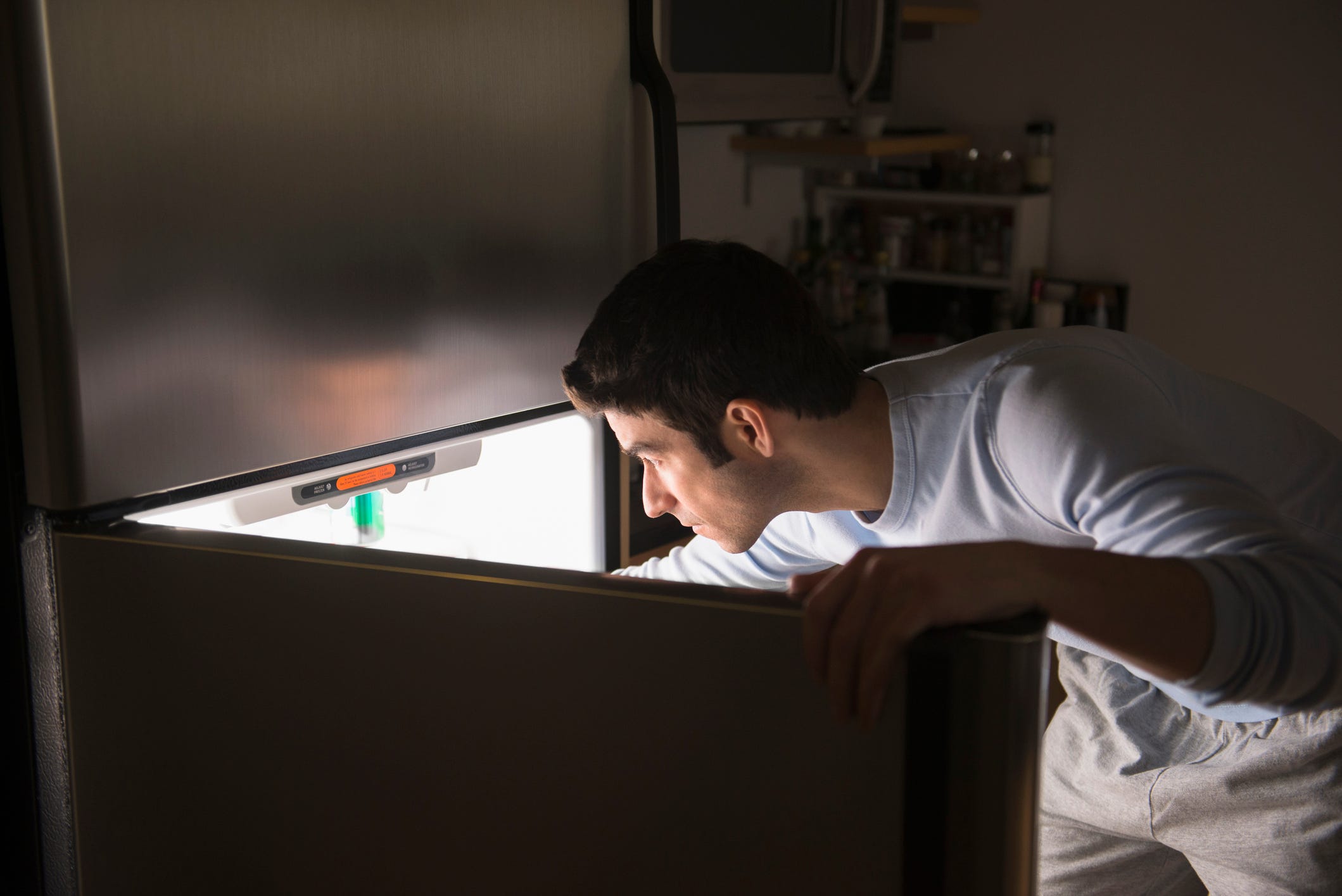 USA, New Jersey, Jersey City, Man opening fridge at night