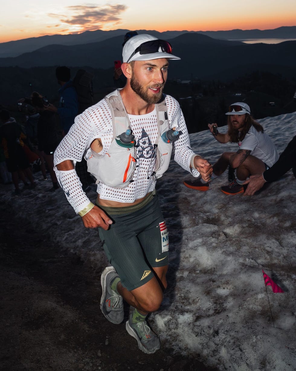 athlete participating in a mountain run event wearing a hydration pack and running gear