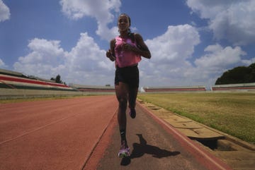 athlete sprinting on a track in a stadium