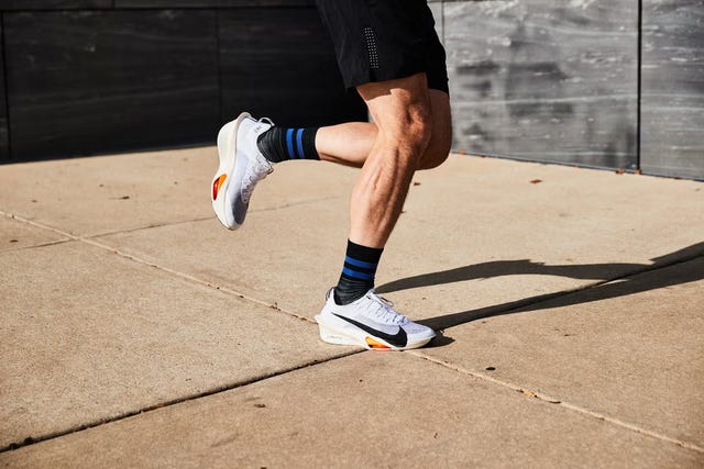 a person jogging in athletic footwear and shorts