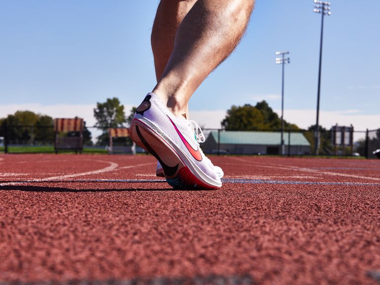 Free Stock Photo of A cute young girl on a track field preparing to race