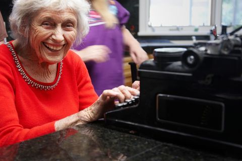 Ninety year lady on old typewriter