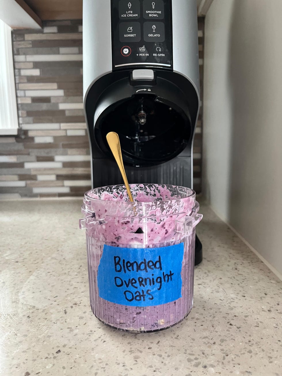 container of blended overnight oats next to a kitchen appliance