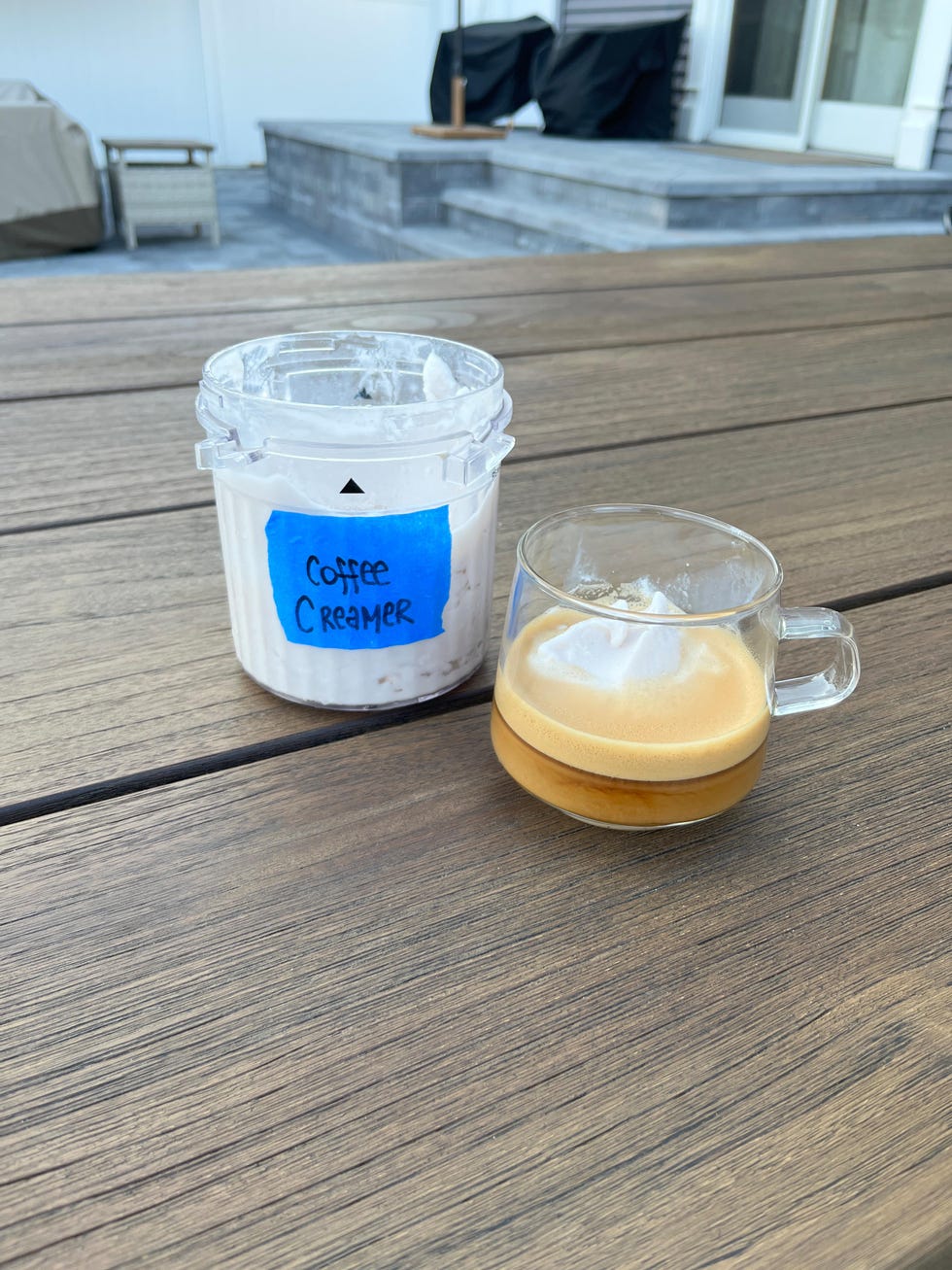 ninja creami pint of frozen blended coffee creamer next to a glass mug of espresso and affogato