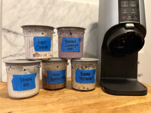 containers of frozen foods next to a ninja creami ice cream maker