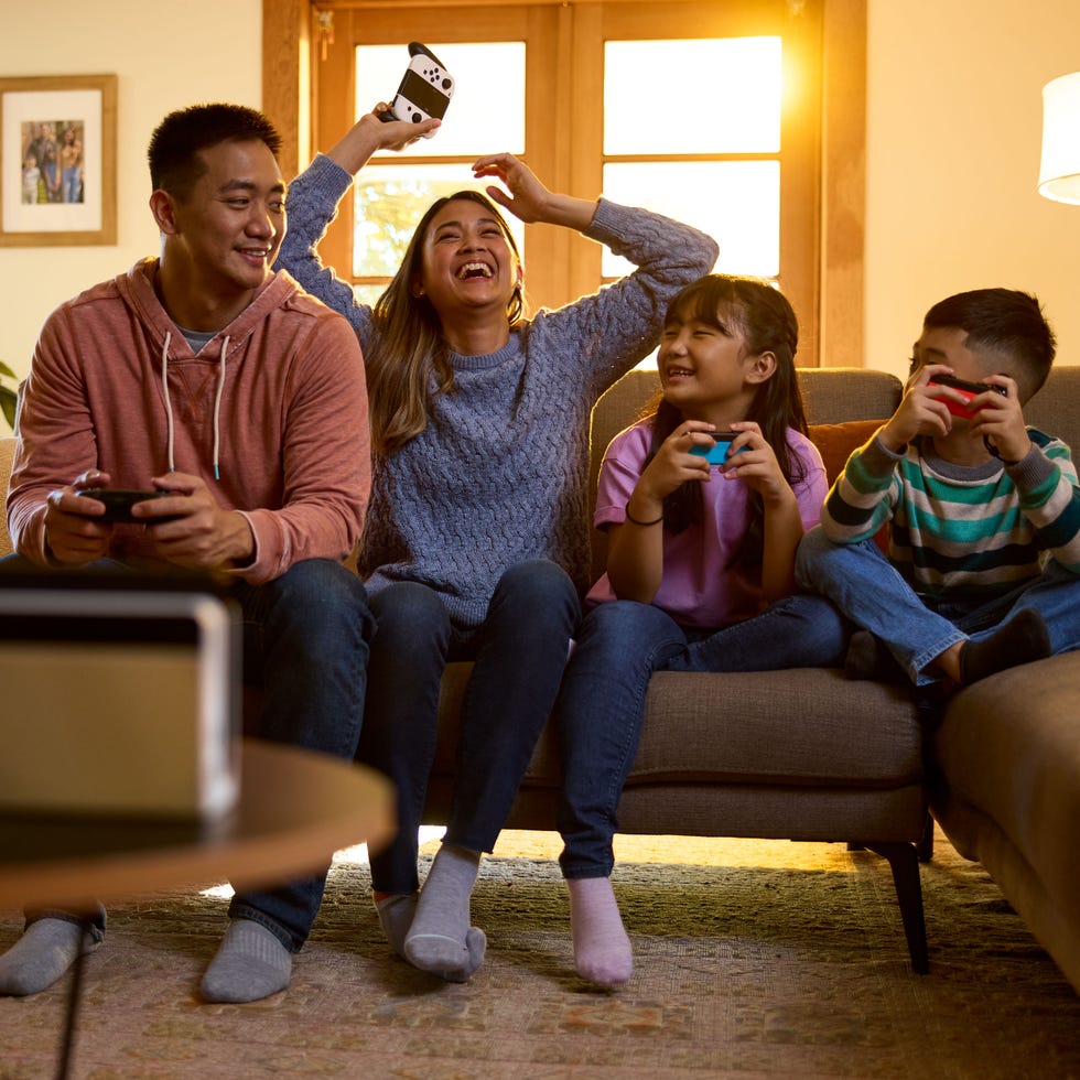 family enjoying a video game together in a cozy living room