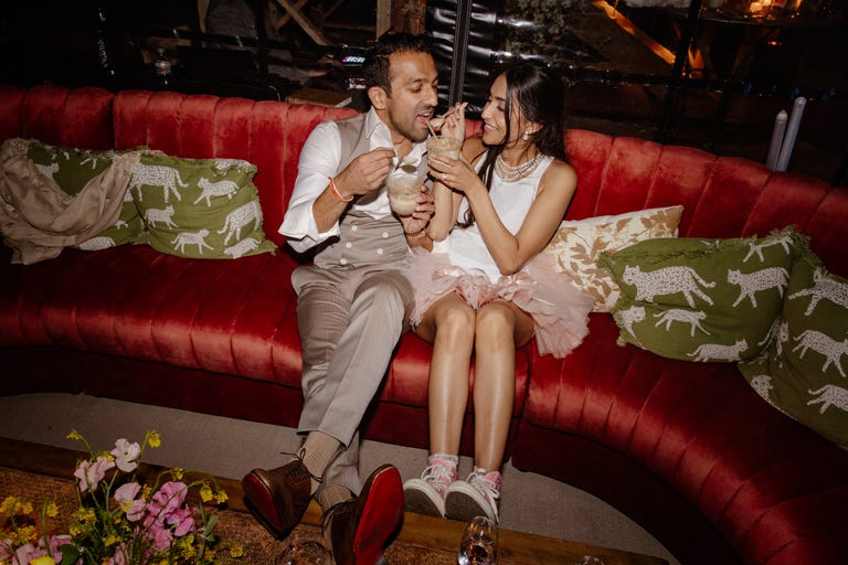 a bride and groom having dessert