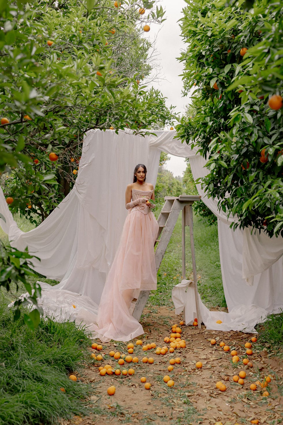 a woman standing on a ladder in a wedding dress