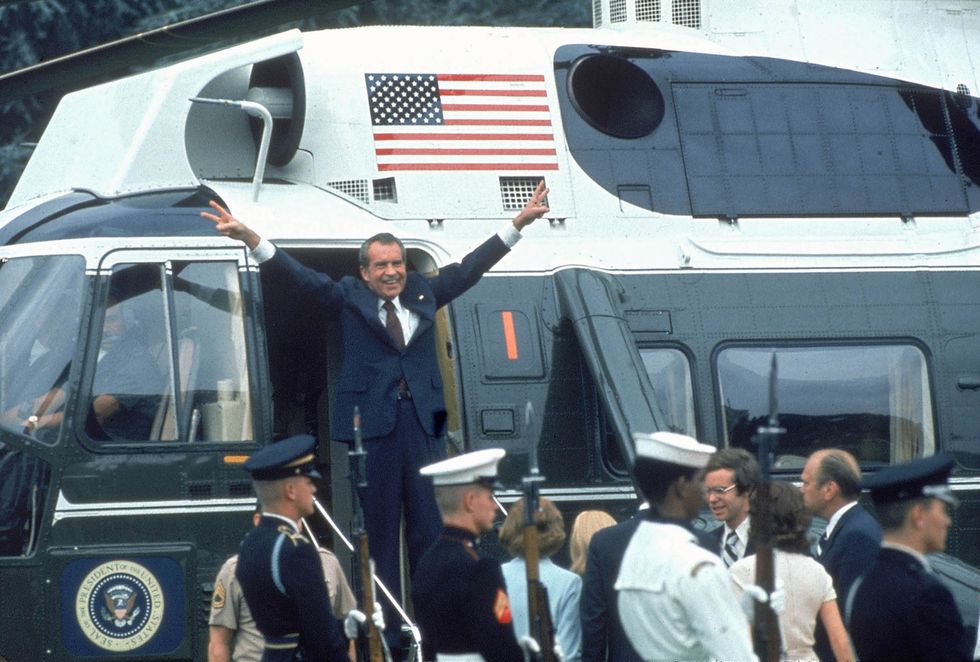 Pres. Richard Nixon w. arms outstretched w. veed f