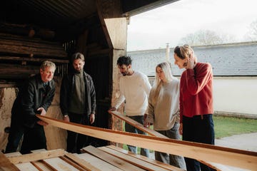 a group of people looking at planks of wood