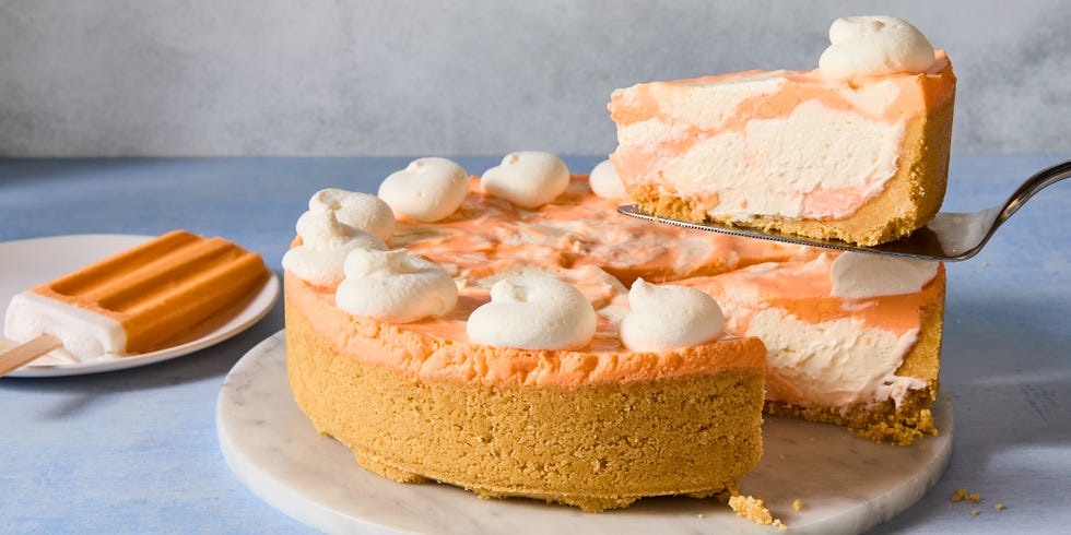 no bake creamsicle cheesecake with dollops of whipped cream and a graham cracker crust