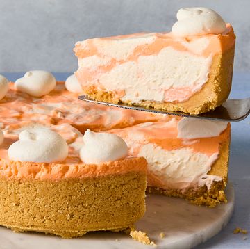 no bake creamsicle cheesecake with dollops of whipped cream and a graham cracker crust
