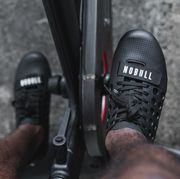 man wearing nobull cycling shoes on indoor bike