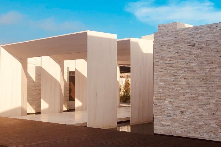 modern architectural structure featuring a blend of stone and concrete elements modern architectural structure featuring a blend of stone and concrete elements