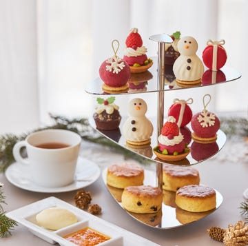 a table with cupcakes and a glass of wine