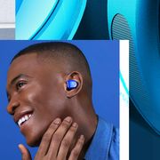 jabra earbuds in charging case and person wearing blue master and dynamic earbuds