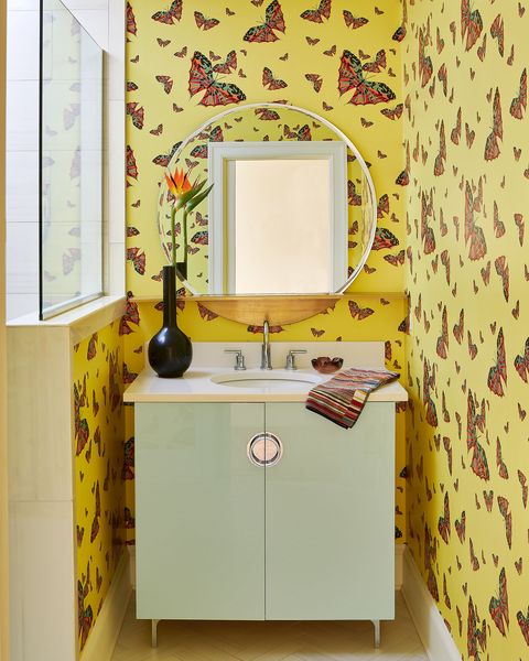 powder room with mint sink cabinet and butterfly wallpaper