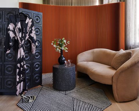 nook with curved tan couch and room dividers