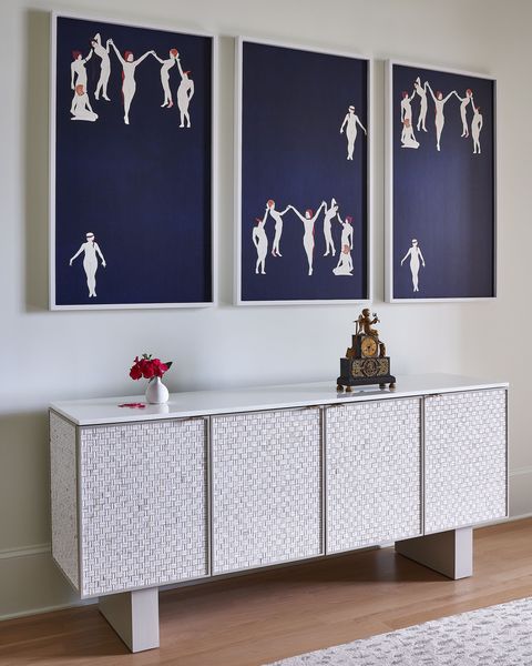 white storage cabinet with large art above