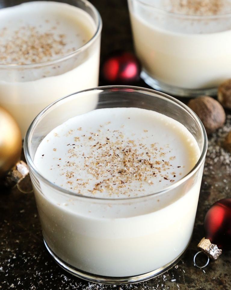 eggnog in short glass with ornaments around