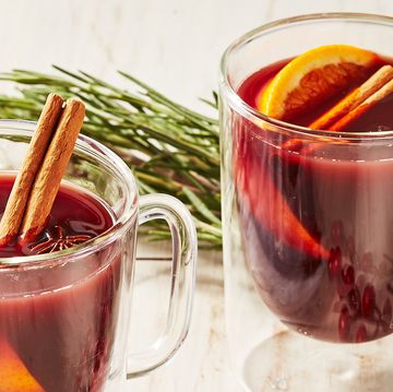 nonalcoholic mulled wine in a glass mug garnished with cinnamon sticks, star anise, and an orange wedge