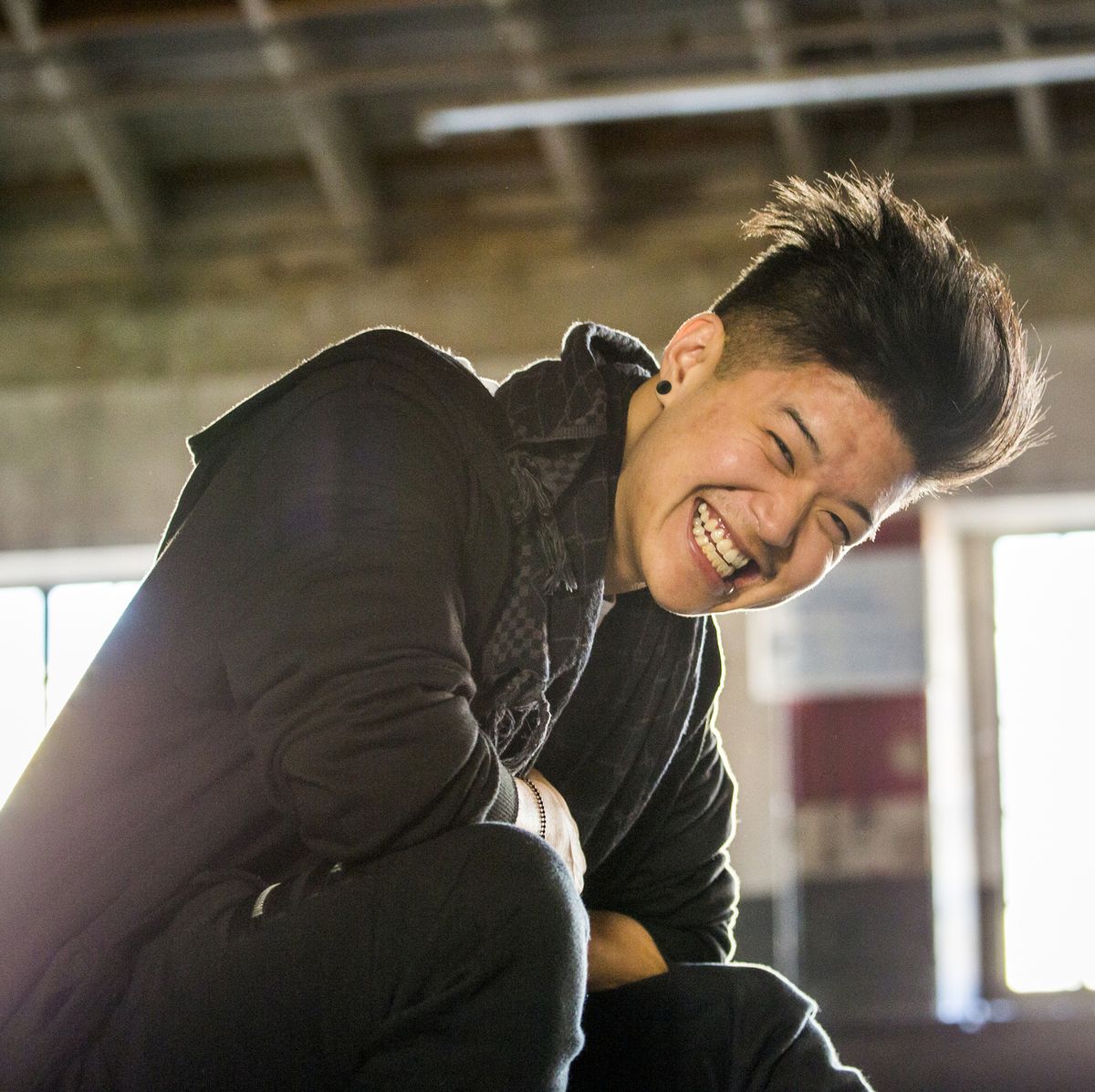 Portrait of laughing androgynous Asian man