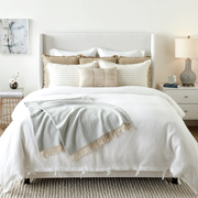 white comforter with tan throw pillows