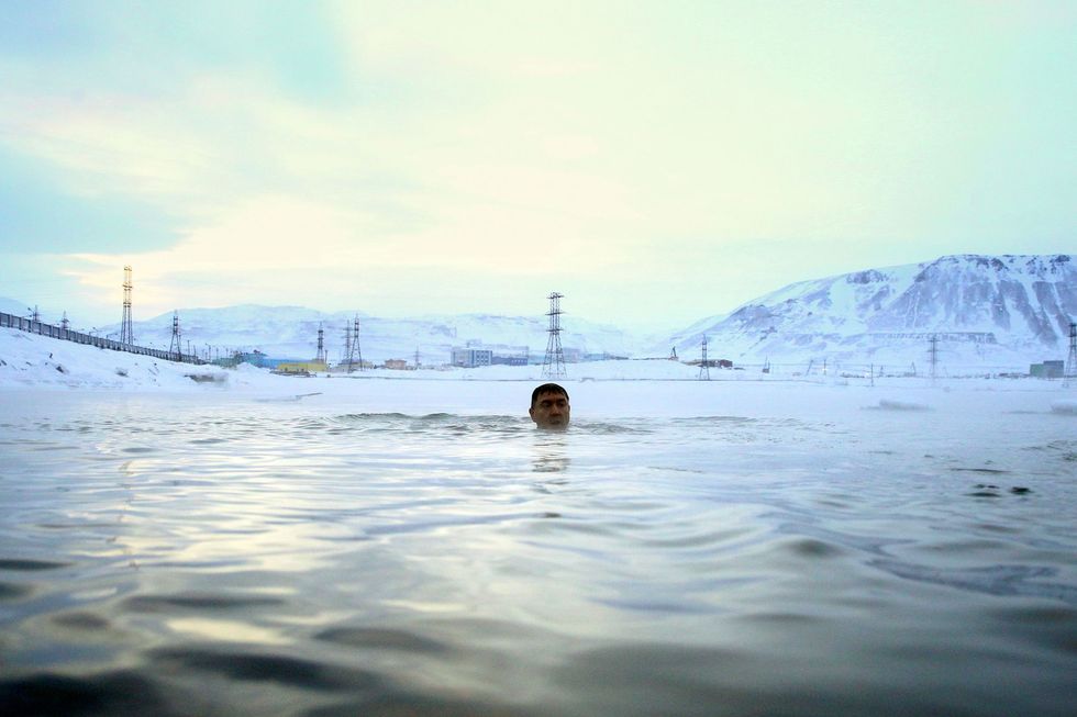 topshot   an orthodox believer swims in the cold waters in norilsk during the epiphany holiday on january 19, 2020 photo by irina yarinskaya  afp photo by irina yarinskayaafp via getty images