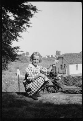 norma jeane baker, future film star marilyn monroe playing with dogs in a rural garden circa 1933