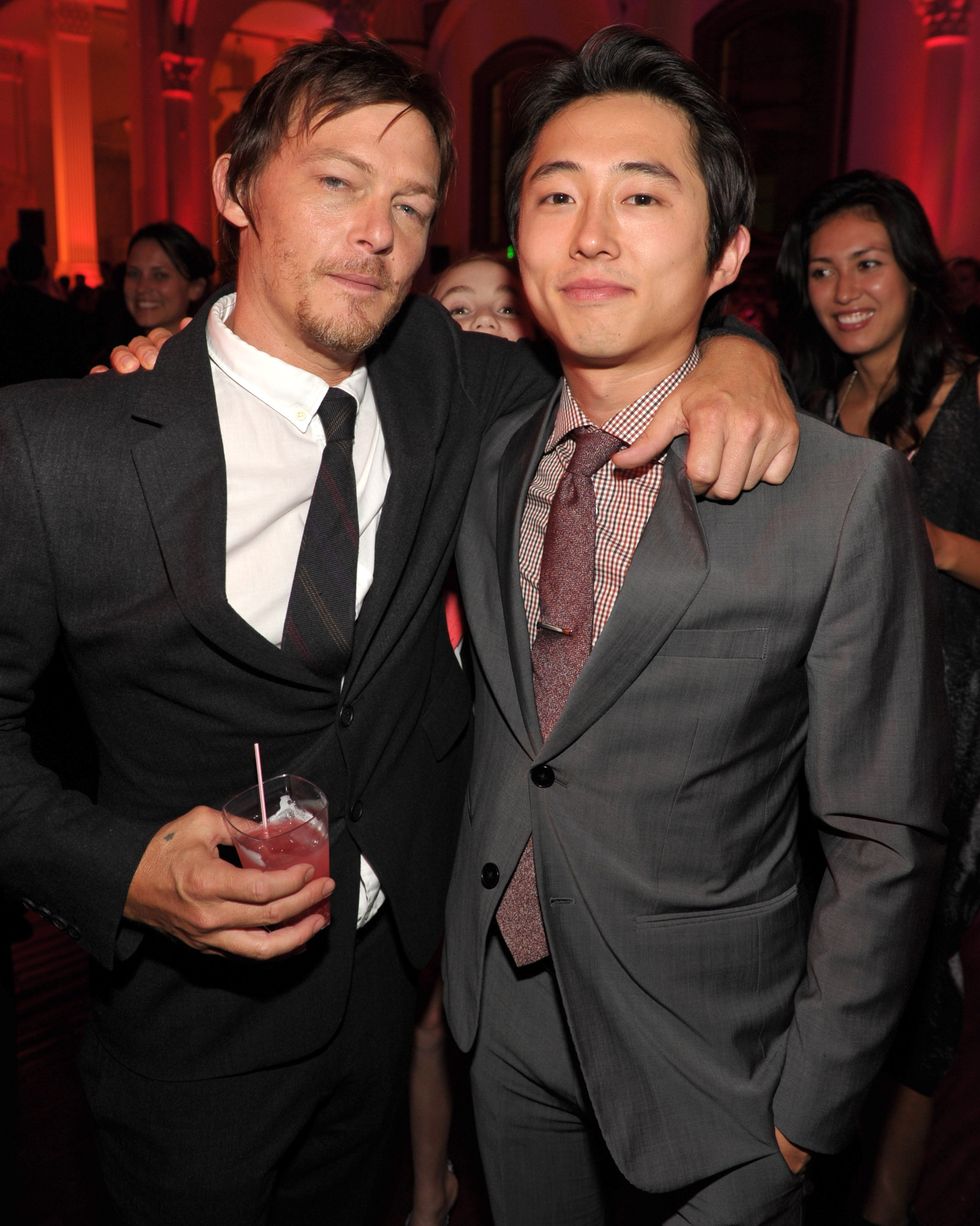 norman reedus and steven yeun standing together for a photograph