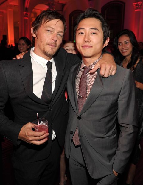 norman reedus and steven yeun standing together for a photograph