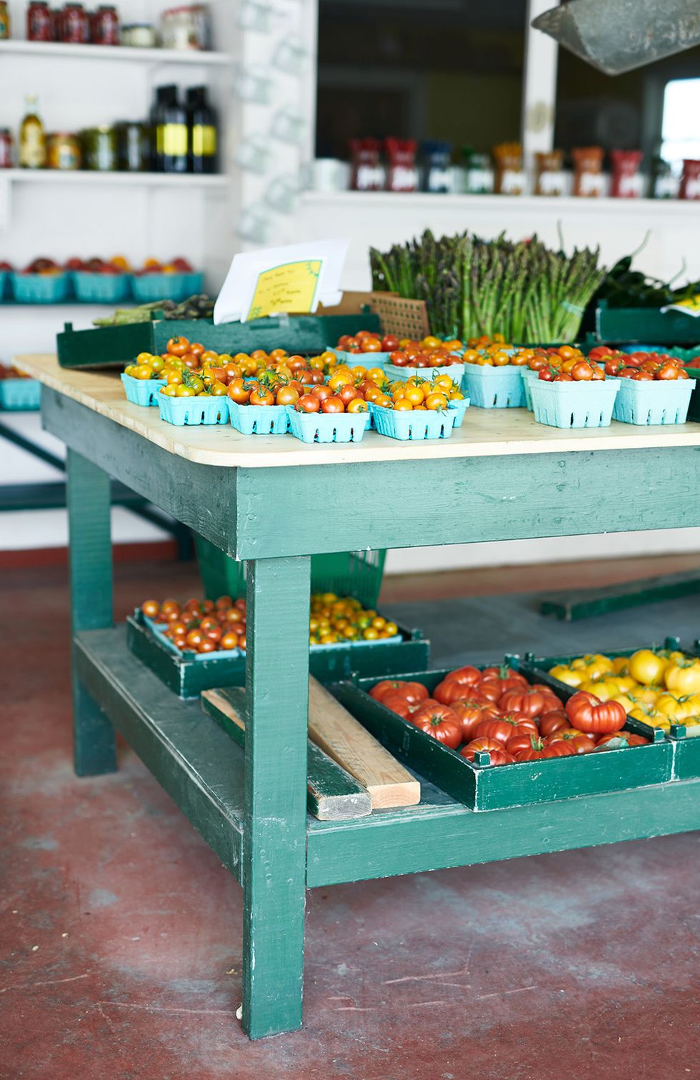 green table filled with tomatoes at wickhams fruit farm in greenport new york
