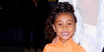 north west in an orange dress