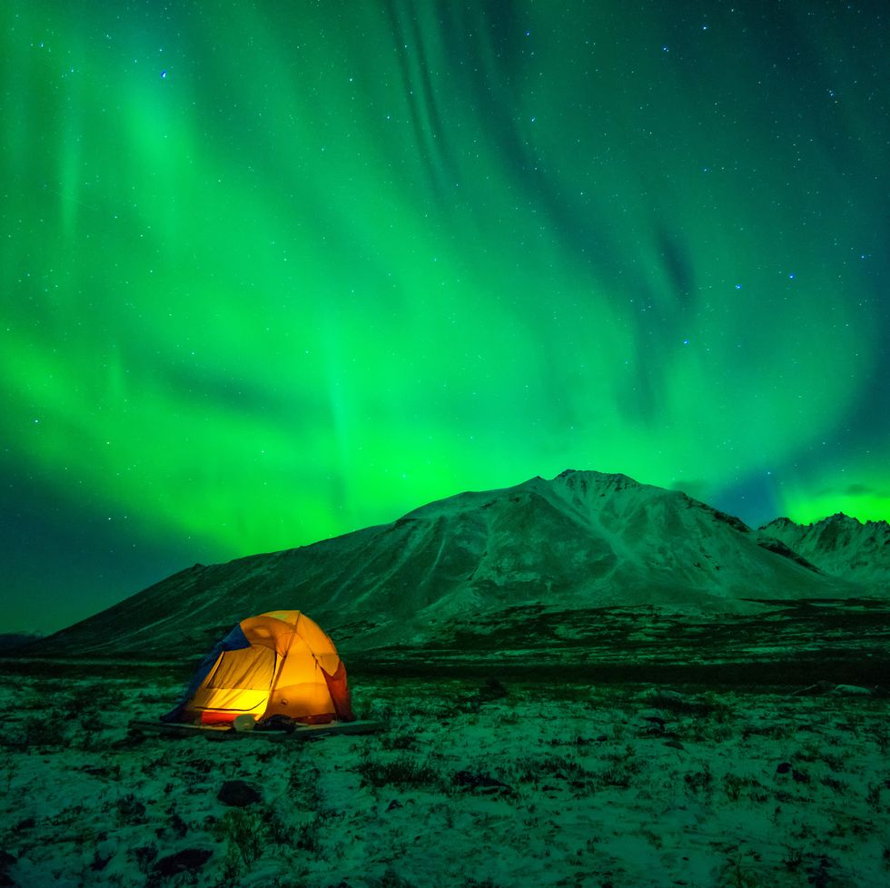 tent camping under northern lights aurora borealis at tombstone territorial park in yukon