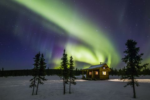 northern lights over alaska wilderness cabin