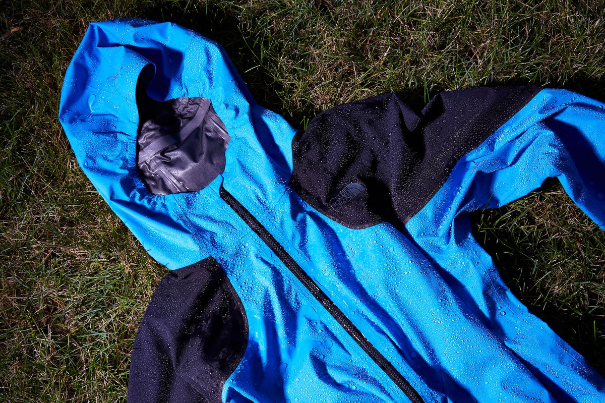 a wet north face raincoat on the ground